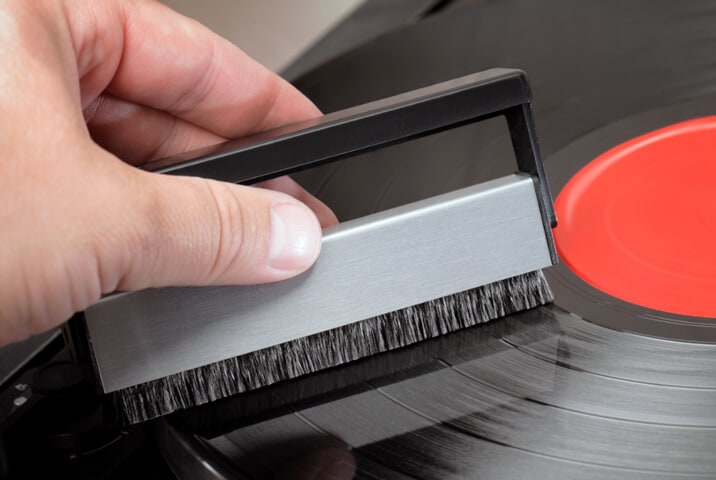 brush-cleaning a vinyl record